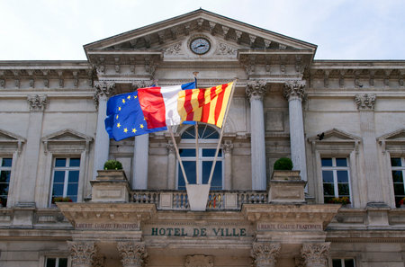 avignon,france-june 19, 2015: town hall in the french city of avignon with flags and clockのeditorial素材
