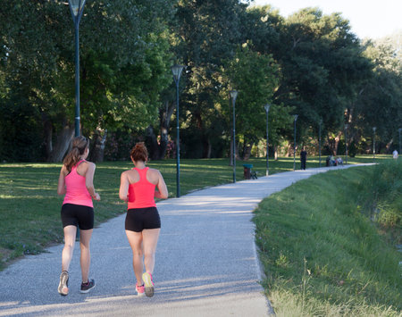 avignon,france-june 19, 2015: two woman joggin in a park in avignonのeditorial素材