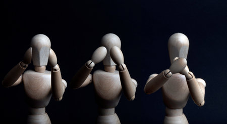 Hear, see and be silent shown by a wooden mannequinの写真素材