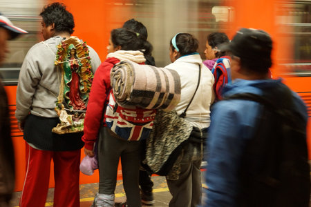 MEXICO CITY, MEXICO  December 12, 2015: Unknown pilgrims in a subway station on their way to the...
