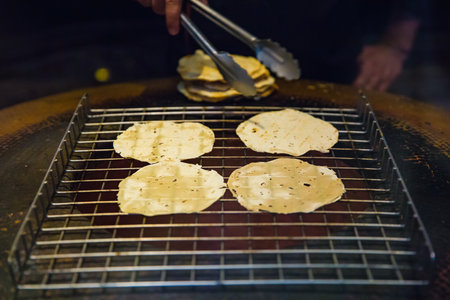 cooking background, grill naan bread on stove. Indian food, selective focus.の写真素材