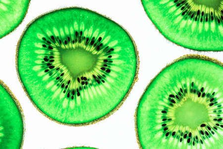 Still life picture, Abstract  fruit background is close up on Kiwi sliced, to show a detail on fresh kiwi face with white backgroundの写真素材