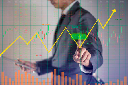 Businessman is analyzes risk management in stock market, He is pointing touch screen to buy on growth up hologram chart, business background.の写真素材