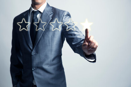 Businessman is give star rating, business background, level business service and product.の写真素材