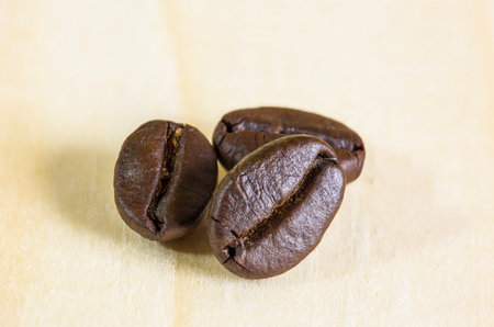 Close up coffee beans on wooden background and effect filter.の写真素材