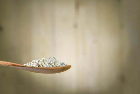 Close up jobs's tear on wooden spoon with wooden background.の写真素材