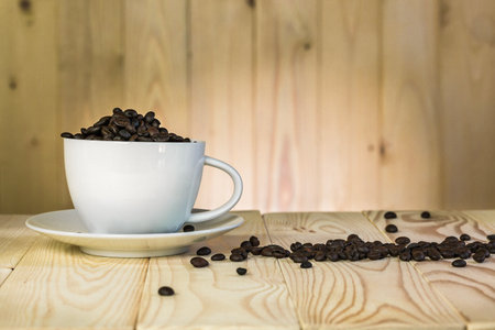 coffee beans in cup with  wooden background and effect filter.の写真素材