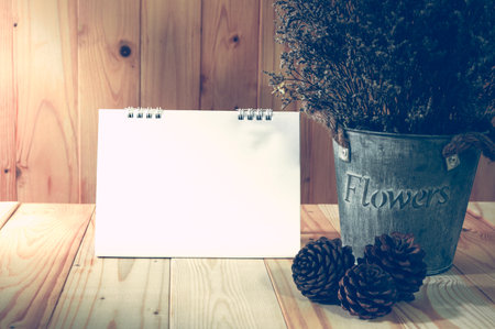 Vintage background, decorate dry flower set on wooden table with blank note, vintage filter and low key.の写真素材