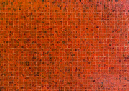 Close up on detail of a beautiful orange ceramic mosaic decorate on wall, abstract background.の写真素材