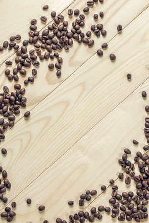 The top view, coffee beans on wooden background and effect filter.の写真素材