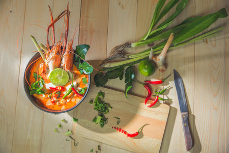 Top view "Tom Yum Kung" on wooden background, It's local in Thai food, Prawn soup is popular and famous food, I'ts delicious amazing taste hot and spicy.の写真素材