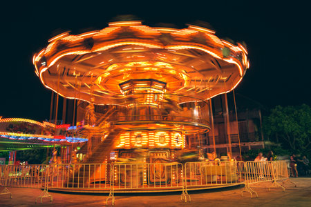 Selective focus to some part flying horse carousel, carnival background with Vintage filter.の写真素材
