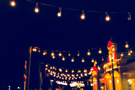 Selective focus on Light bulbs and  bokeh background with effect filter, Abstract background, vintage tone at night light festival.の写真素材