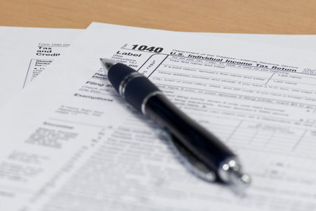 Close up of a 1040 IRS Tax Form with a Blue Pen