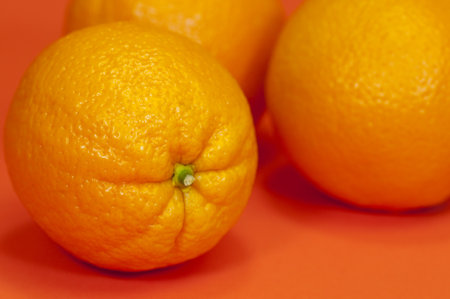 Fresh oranges on an orange background
