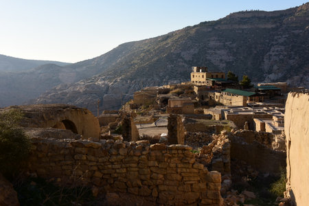 Mountain village over barren landscape in the evening lightの写真素材