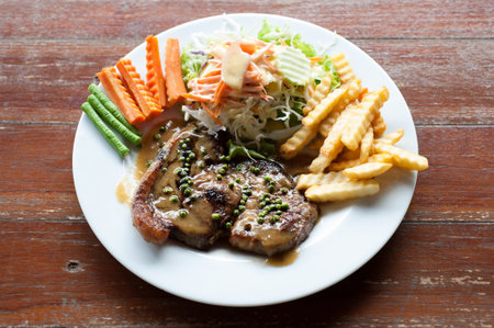 Grilled steaks with Pepper sauce, French fries and vegetables