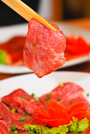 Korean food Beef Sliced holding with chopstickの写真素材