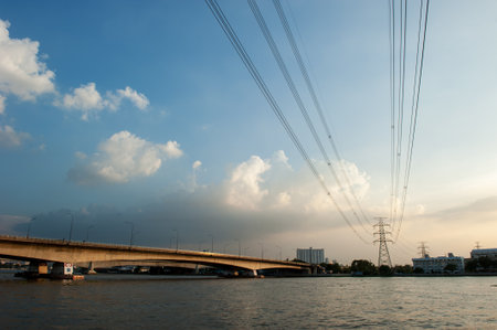 high voltage towers and bridge with sunset skyの写真素材
