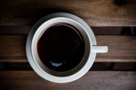 Top View a cup of coffee on the wooden background