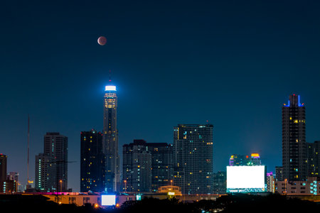 BANGKOK - April 4 : Blood moon with Business building on April 4, 2015 at Bangkok, Thailandのeditorial素材