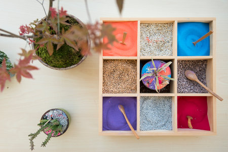 colored sand decoration in square wood box with  wooden spoonの写真素材