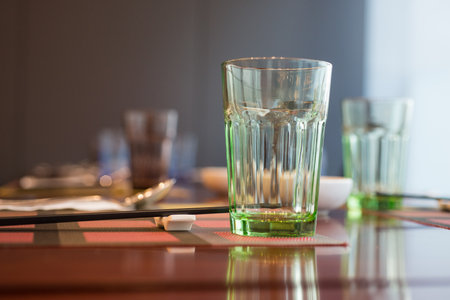 Set up Glasses and plates on table in restaurantの写真素材