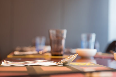 Set up Glasses and plates on table in restaurantの写真素材