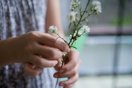 hand holding flower during flower decorateの写真素材