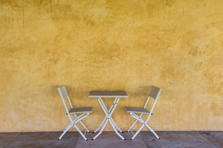 picnic table set with yellow painting wall