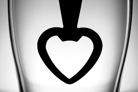 heart shaped bottle opener in glassesの写真素材