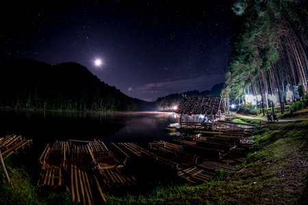The beautiful night sky with light of moon and milkyway at Pang Ung Lake in Mae Hong Son's city, North of THAILAND.の写真素材
