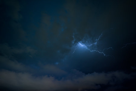 Stroke of lightning with storm clouds