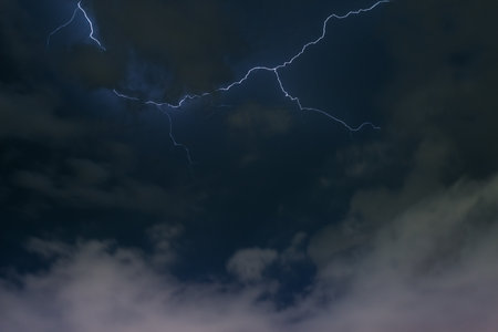 Stroke of lightning with storm clouds