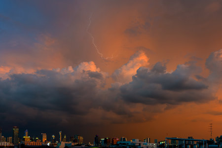 storm clouds above bangkok city with beautiful sunset lightの写真素材