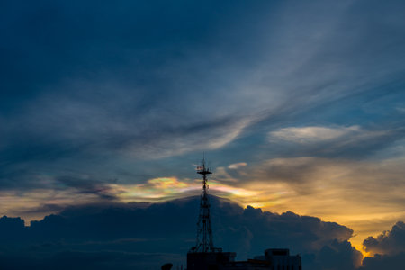 Silhouette of cellular tower with beautiful sunset cloudy sky