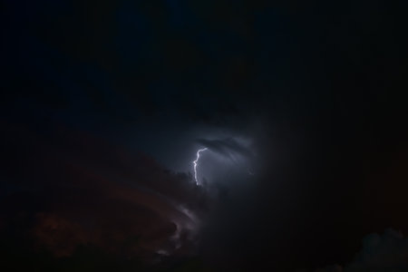 Stroke of lightning with storm clouds