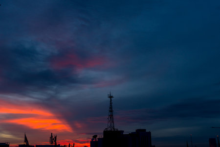 Silhouette of cellular tower with beautiful sunset cloudy skyの写真素材