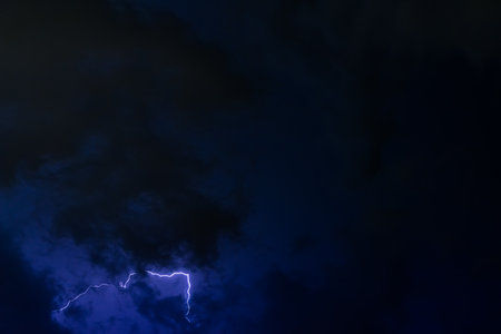 Stroke of lightning with storm cloudsの写真素材