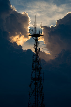 Silhouette of Signal Tower with beautiful Cloudy sunset sky background