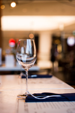 Empty Wine Glasses on table in restaurantの写真素材