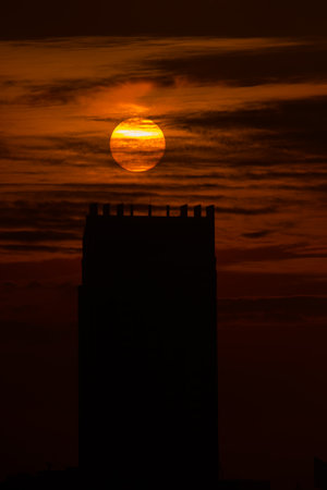 Silhouette of building with beautiful sunrise backgroundの写真素材