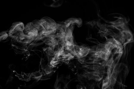 White smoke isolated on black background.の写真素材