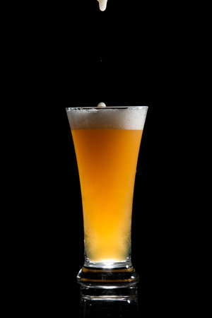 craft beer glass on black backgroundの写真素材