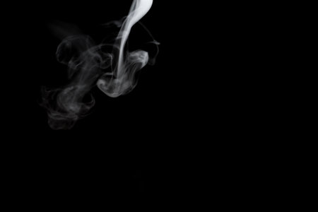 White smoke isolated on black background.の写真素材