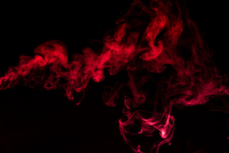 Red smoke isolated on black background.の写真素材