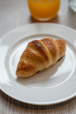 Plain croissant on white plateの写真素材