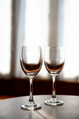 Empty Wine glasses with blur curtain backgroundの写真素材