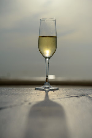 champagne glass with blurred sea and sky backgroundの写真素材