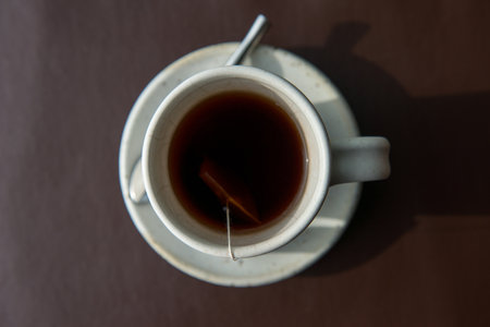 Hot tea served in a mug with milk and sugarの写真素材